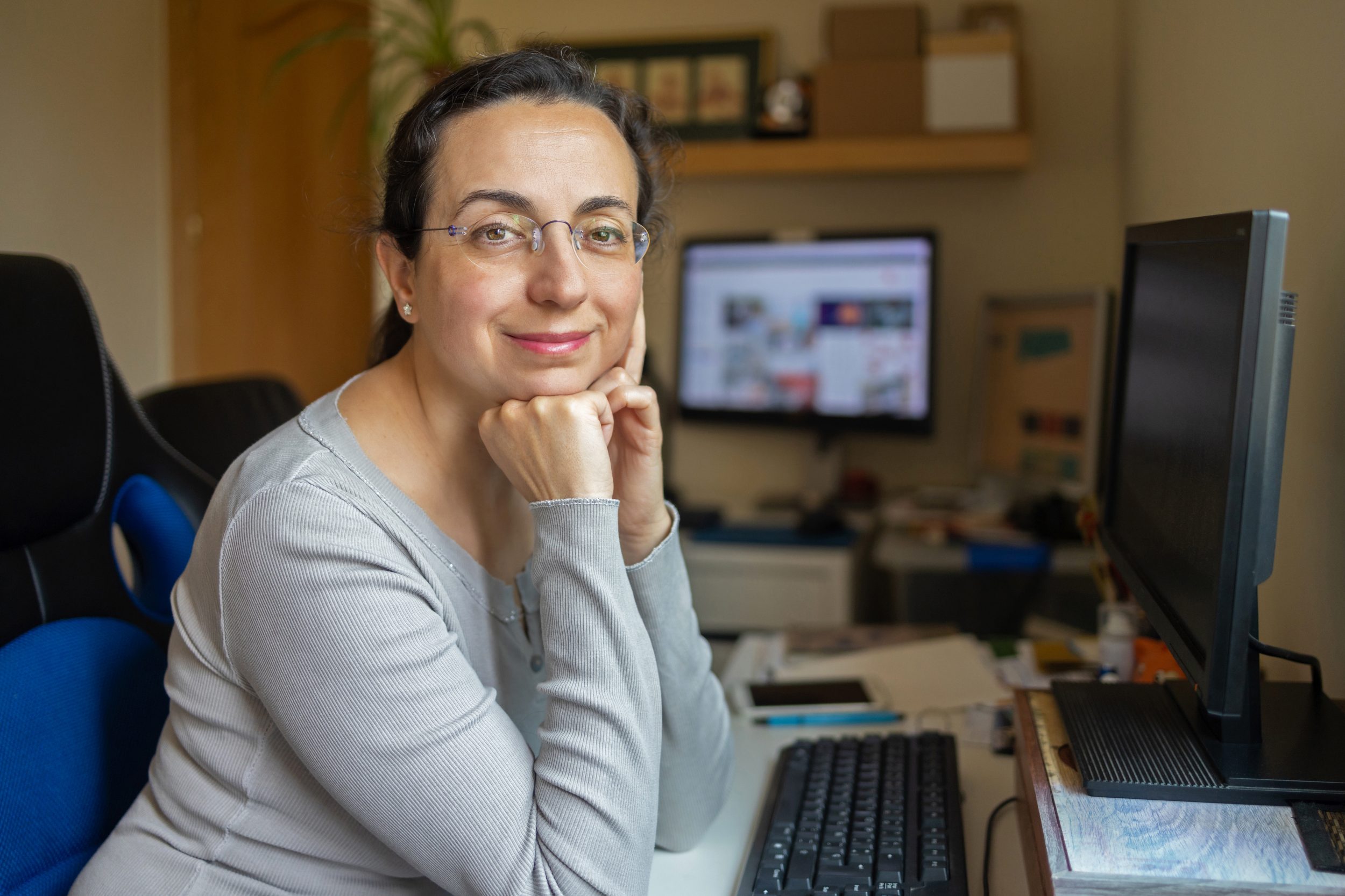 Middle Aged Pretty Woman With Glasses Looking To The Camera And Smiling