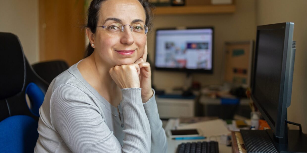 Middle Aged Pretty Woman With Glasses Looking To The Camera And Smiling